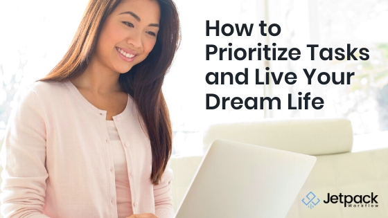 How to Prioritize Tasks and Live Your Dream Life woman smiling at laptop working remotely