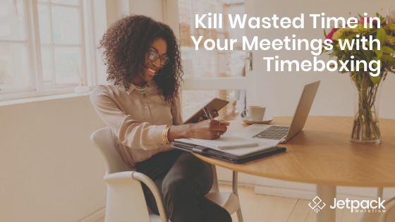 kill wasted time in your meeting with timeboxing- woman using laptop and taking notes happily working from home