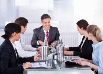Businesspeople Sitting At Conference Table
