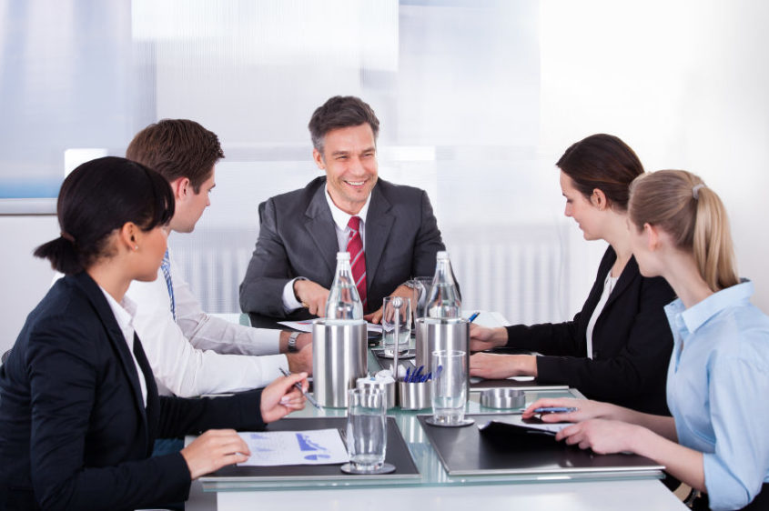 Businesspeople Sitting At Conference Table